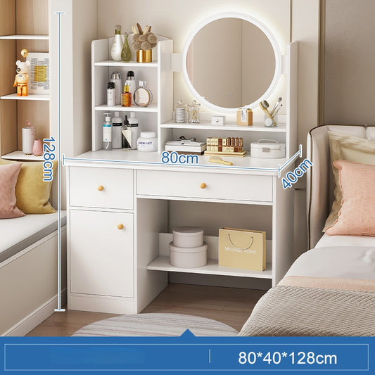 A white dressing table with LED lights around the mirror, placed in a bedroom setting with various cosmetic items arranged on it.