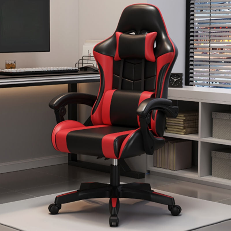A black and red high-back gaming office chair with a chrome gas lift and 360-degree swivel base, positioned in a room with a computer setup.
