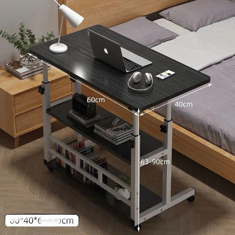 Adjustable laptop desk with wheels and shelves, placed next to a bed with dimensions marked on the desk surface.